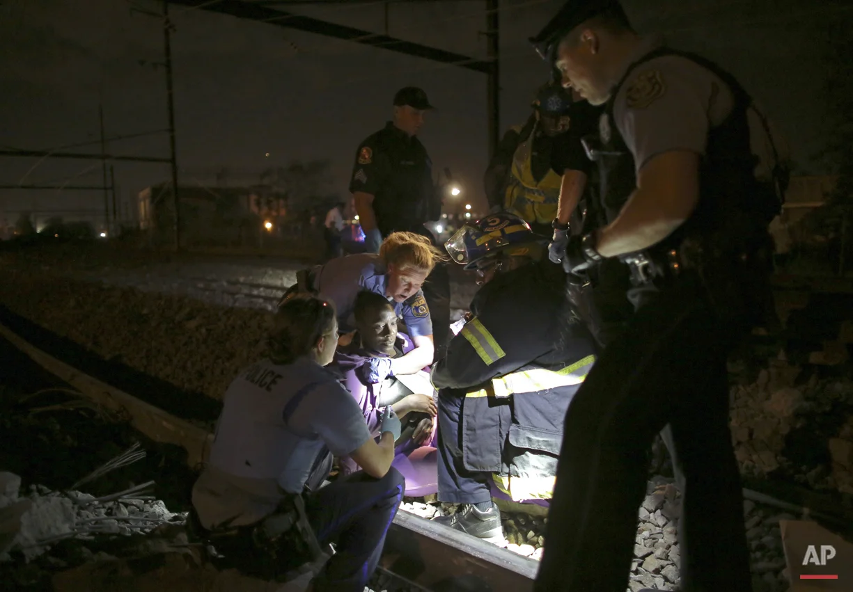 Emergency personnel work the scene of a Amtrak train wreck, Tuesday, May 12, 2015, in Philadelphia. (AP Photo/ Joseph Kaczmarek)