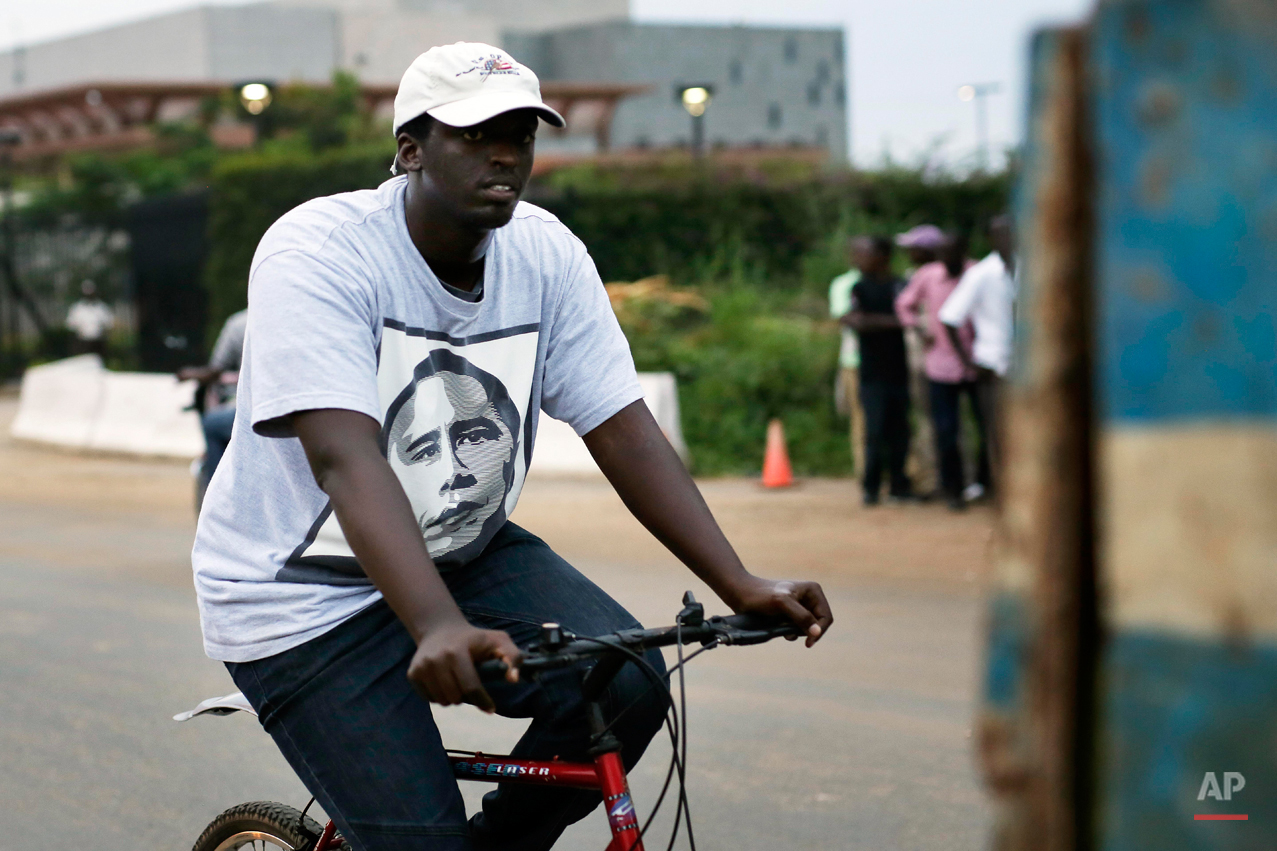  In this photo taken Saturday May 30, 2015, a man rides his bicycle wearing a T-shirt with the portrait of U.S. President Barak Obama in Bujumbura, Burundi. Barack Obama, the United Statesí first African-American president, has captured the imaginati