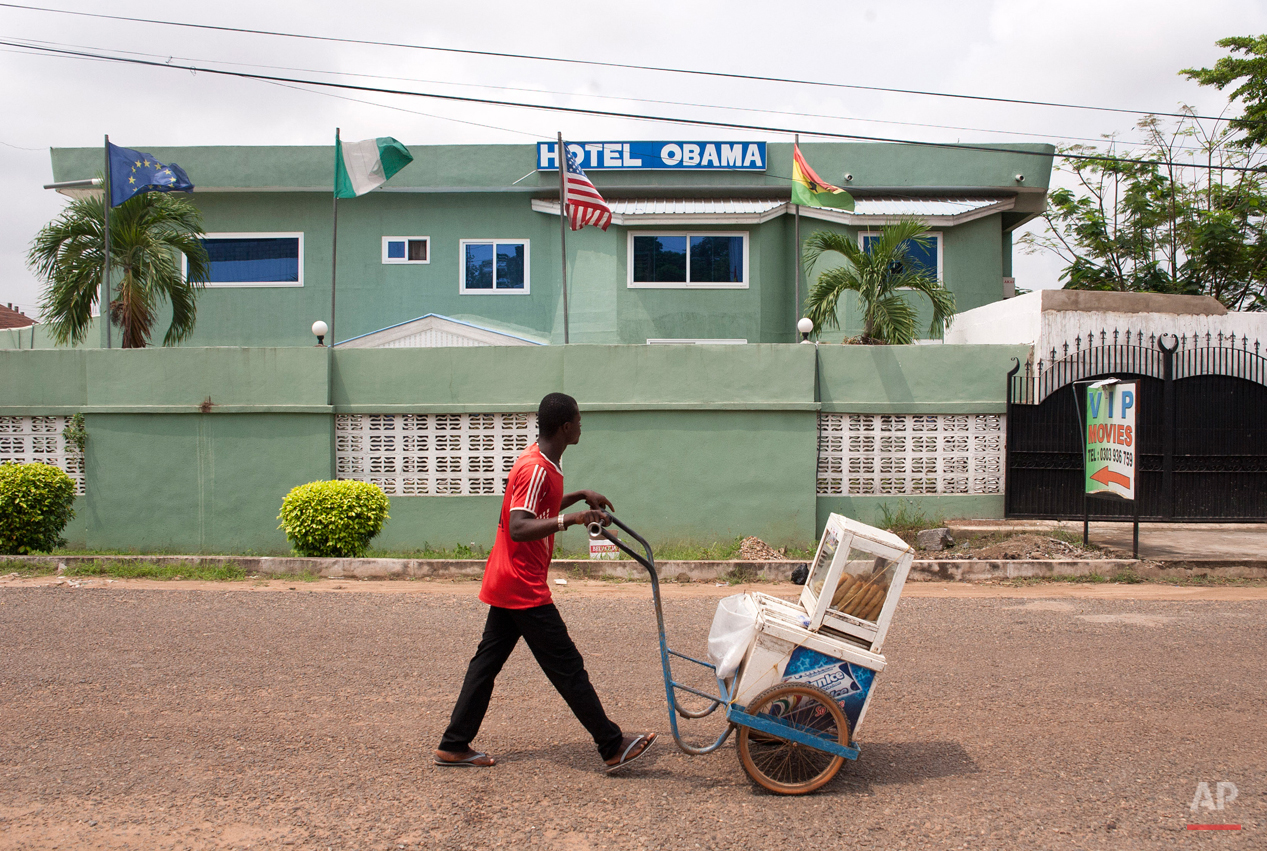  In this picture taken on Saturday, July 4, 2015, an ice cream vendor walks by a hotel named after U.S. President Barak Obama in Accra, Ghana. Barack Obama, the United Statesí first African-American president, has captured the imagination of people a