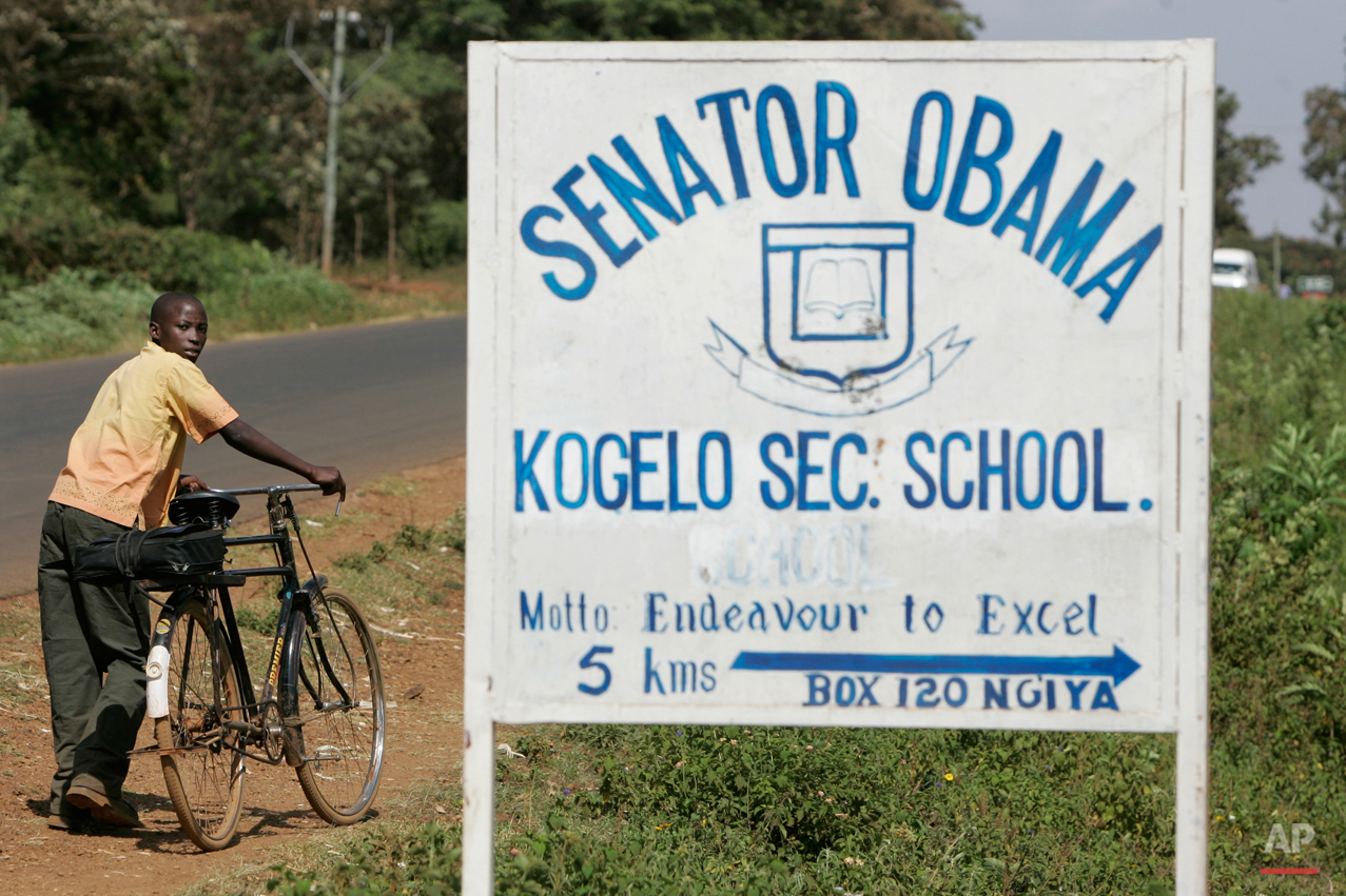  In this Tuesday, Feb. 5, 2008 photo, a boy pushes his bicycle past a sign for the Senator Obama secondary school in the village of Kogelo, Kenya where Barack Obama's grandmother lives. Barack Obama, the United Statesí first African-American presiden