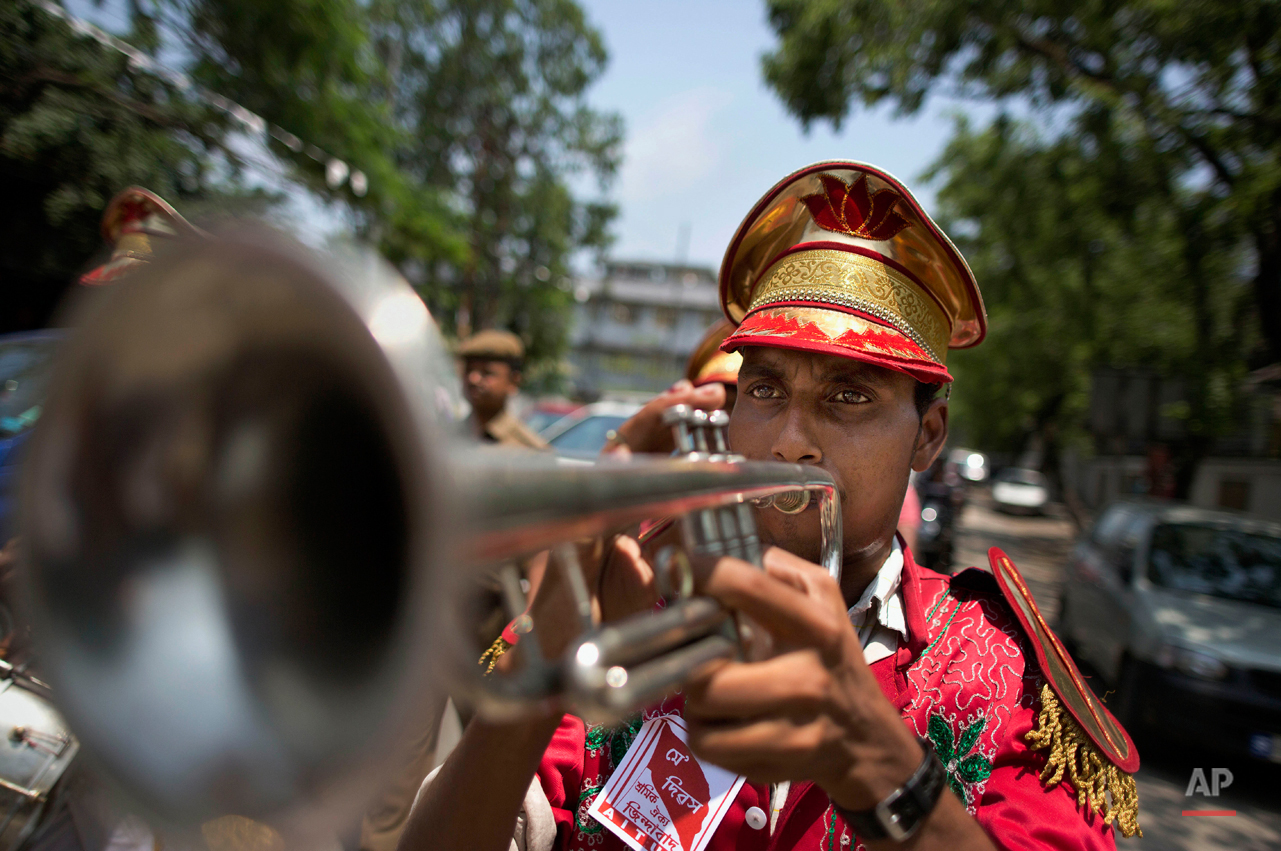  A member of a brass band plays an instrument during a rally to mark May Day in Gauhati, India, Friday, May 1, 2015. May 1 is celebrated as the International Labor Day or May Day across the world. (AP Photo/Anupam Nath) 