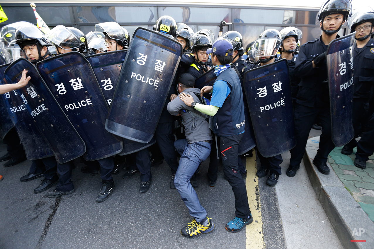  Members of the Korean Confederation of Trade Unions confront with riot police as they march toward the presidential house after a May Day rally in Seoul, South Korea, Friday, May 1, 2015. Thousands of South Koreans marched in Seoul on Friday for a t