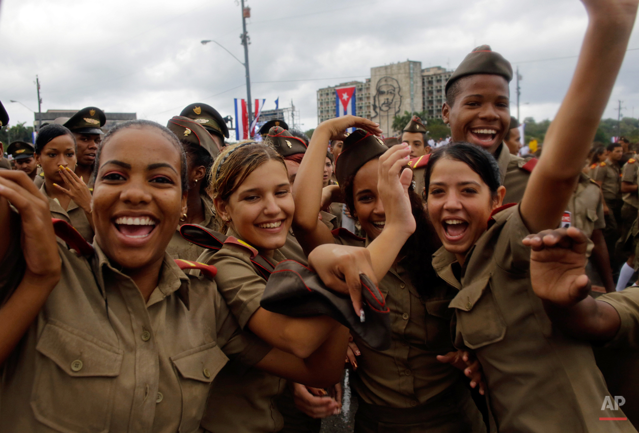  Cuban army cadets react to the photographer as they march in Revolution Square marking May Day, in Havana, Cuba, Friday, May 1, 2015. Thousands of people converged on the plaza for the traditional march, led this year by President Raul Castro and Ve