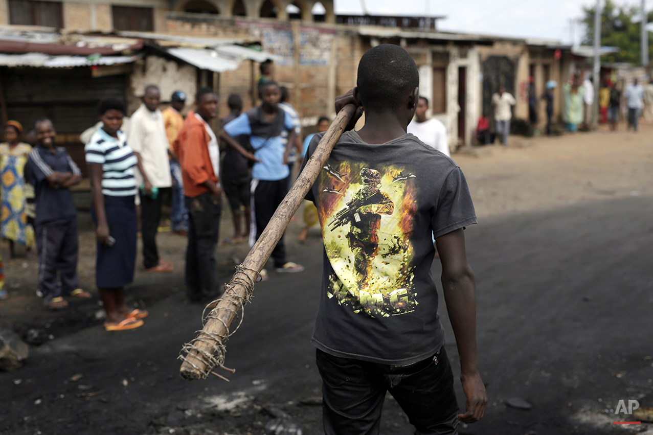  A demonstrator carrying a stick walks in the Musaga neighborhood of Bujumbura, Burundi, Friday May 1, 2015. Anti-government street demonstrations continued for a sixth day in protest against the move by President Pierre Nkurunziza to seek a third te