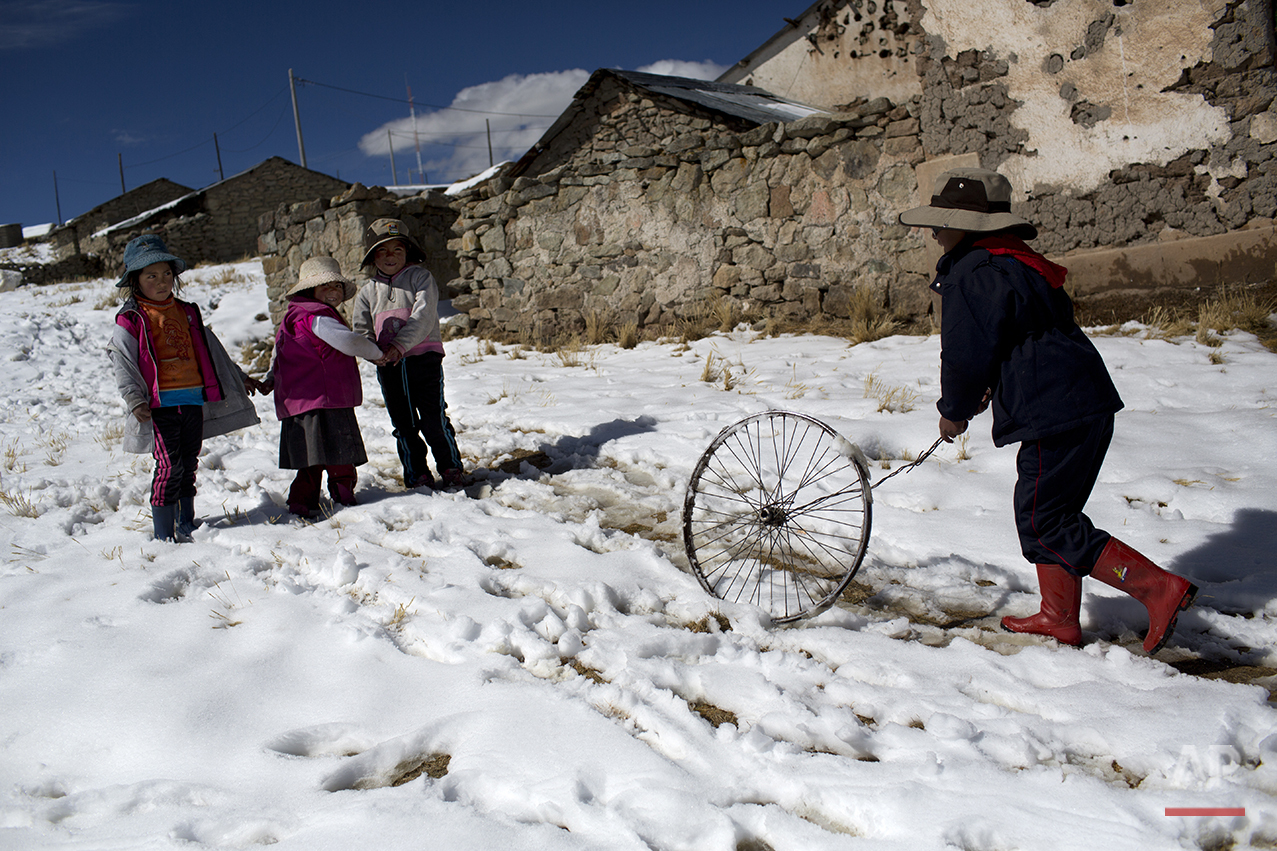  In this July 9, 2016 photo, children play after school in San Antonio de Putina in the Puno region of Peru. Two months into the cold season an estimated 14,000 children in the Andes have suffered from respiratory illnesses and 105 died, according to
