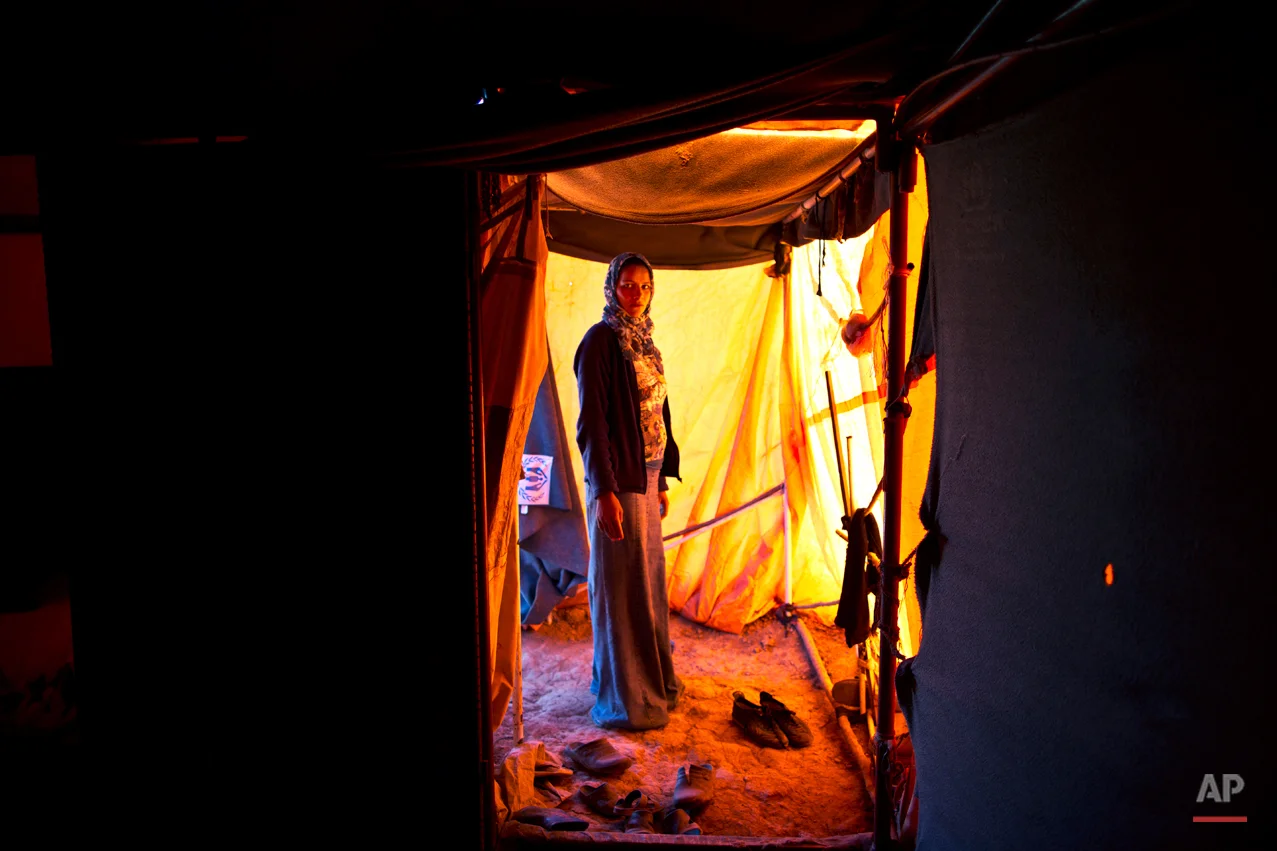  In this Monday, March 16, 2015 photo, Syrian refugee Feedah Ali, 18, who is four months pregnant, poses for a portrait inside her tent at an informal settlement near the Syrian border, on the outskirts of Mafraq, Jordan. Pregnant refugee women livin