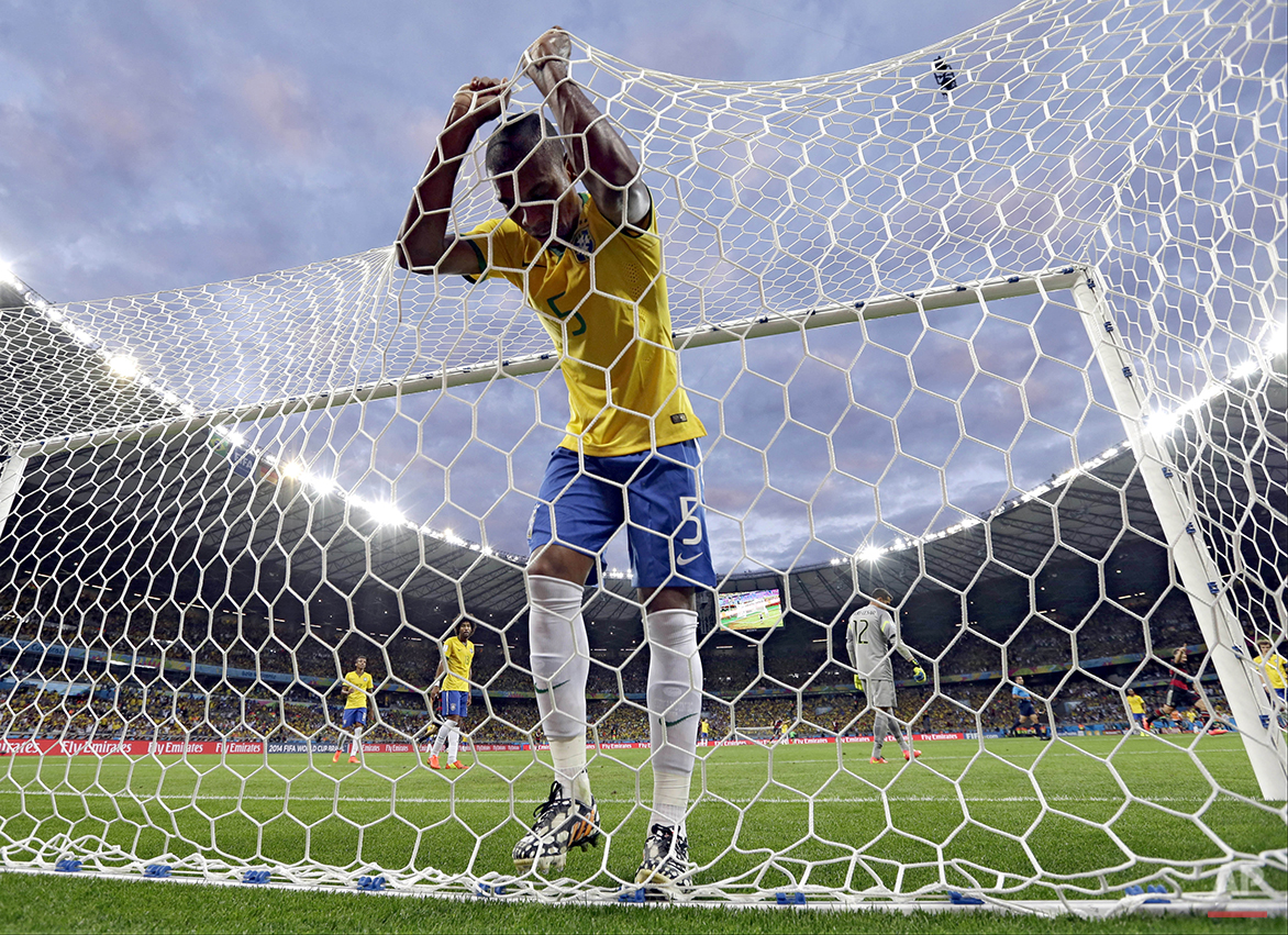  In this July 8, 2014, photo, Brazil's Fernandinho reacts after Germany's Toni Kroosduring scored his side's third goal during the World Cup semifinal soccer match between Brazil and Germany at the Mineirao Stadium in Belo Horizonte, Brazil. (AP Phot