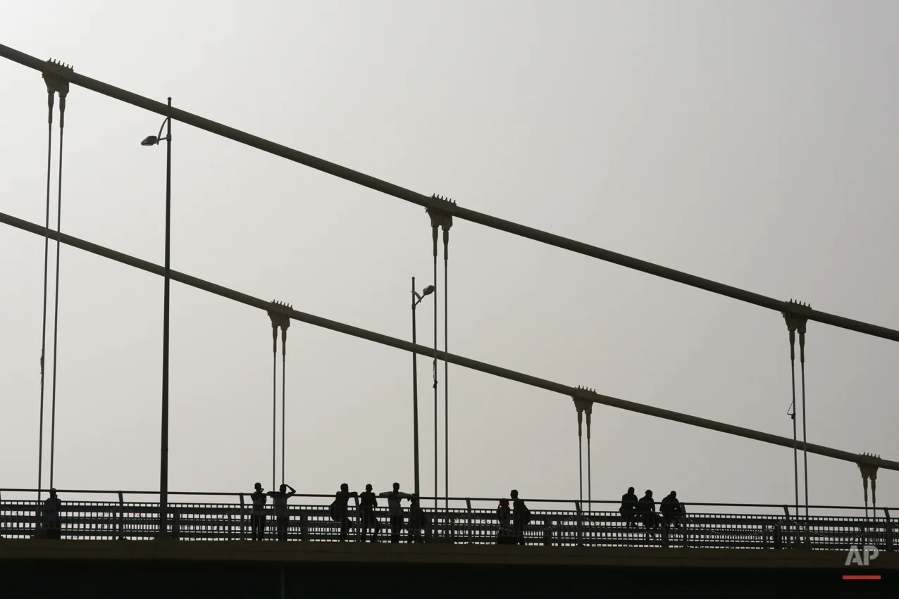  In this Saturday, April 11, 2015 photo, Sudanese youth relax on a bridge during sunset in Khartoum, Sudan. Nearly 13 million people are registered to vote for president and the 450-member legislative council starting Monday. Some 11,000 polling cent