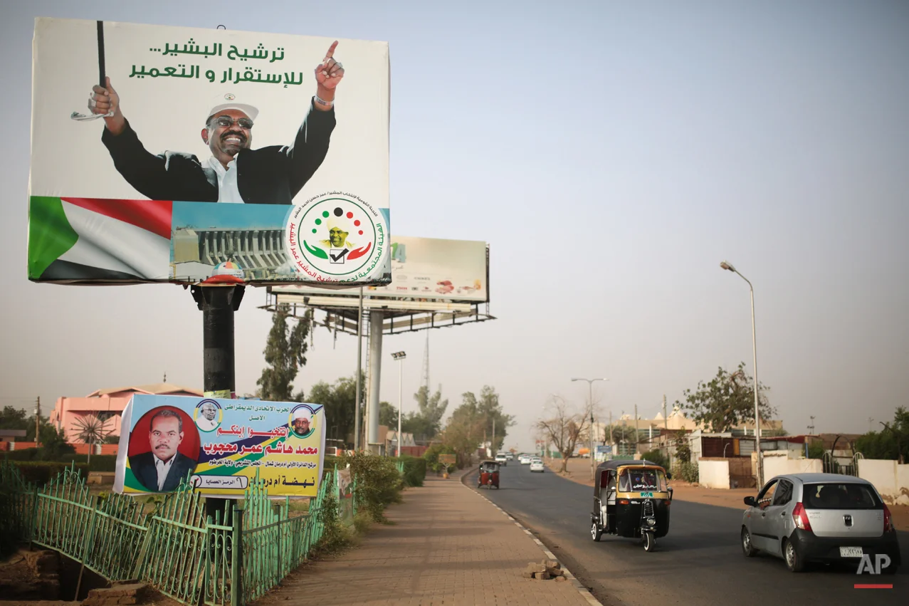  In this Saturday, April 11, 2015 photo, vehicles drive past an election campaign banner in support of President Omar al-Bashir, in Omdurman, Sudan, that reads "Nominating al-Bashir, for stability and reconstruction." Sudanís President Omar al-Bashir