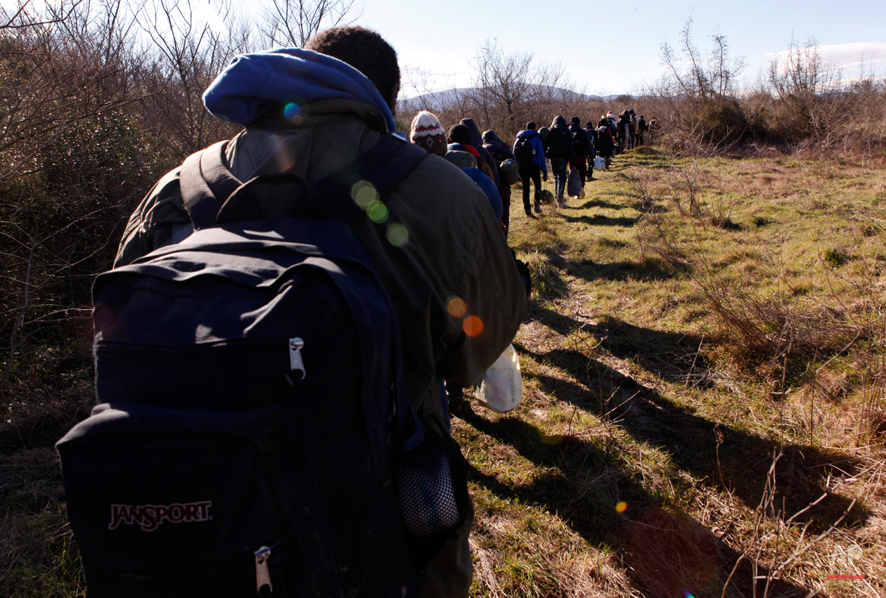  In this Tuesday, March 3, 2015 photo West African migrants walk near the village of Udovo, Macedonia.  The tide of hopeful migrants pours through the vulnerable 'back-door' countries in the hope of entering the 28-nation European Union, and although