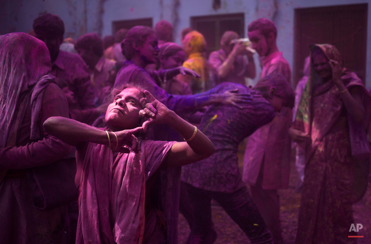 In this Tuesday, March 3, 2015 photo, Indian Hindu widows and others play with colored powder as part of Holi celebrations at the Meera Sahabhagini Widow Ashram in Vrindavan, India. The widows celebrated the Hindu festival of colors at the ashram. (AP Photo/Tsering Topgyal)