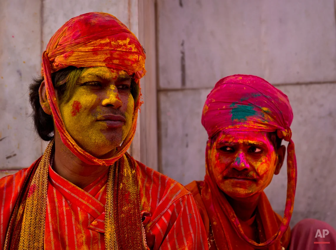 Indian villagers from Nandgaon wait for the arrival of villagers from Barsana at the Nandagram temple, famous for Lord Krishna and his brother Balram, during Lathmar holi festival, in Nandgaon, India, Saturday, Feb. 28, 2015. During Lathmar Holi the women of Nandgaon, the hometown of Krishna, beat the men from Barsana, the legendary hometown of Radha, consort of Hindu God Krishna, with wooden sticks in response to their teasing as they depart the town. (AP Photo/Saurabh Das)