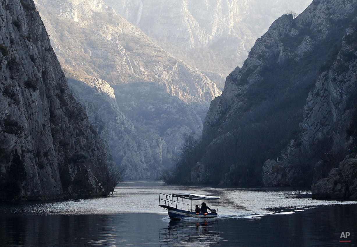  Two people in a small boat sail along Treska River at Matka Canyon, west of Skopje, in Macedonia, Sunday, Feb. 15, 2015. Rivers and water accumulations are full after a period of heavy rains in this Balkan country. (AP Photo/Boris Grdanoski) 