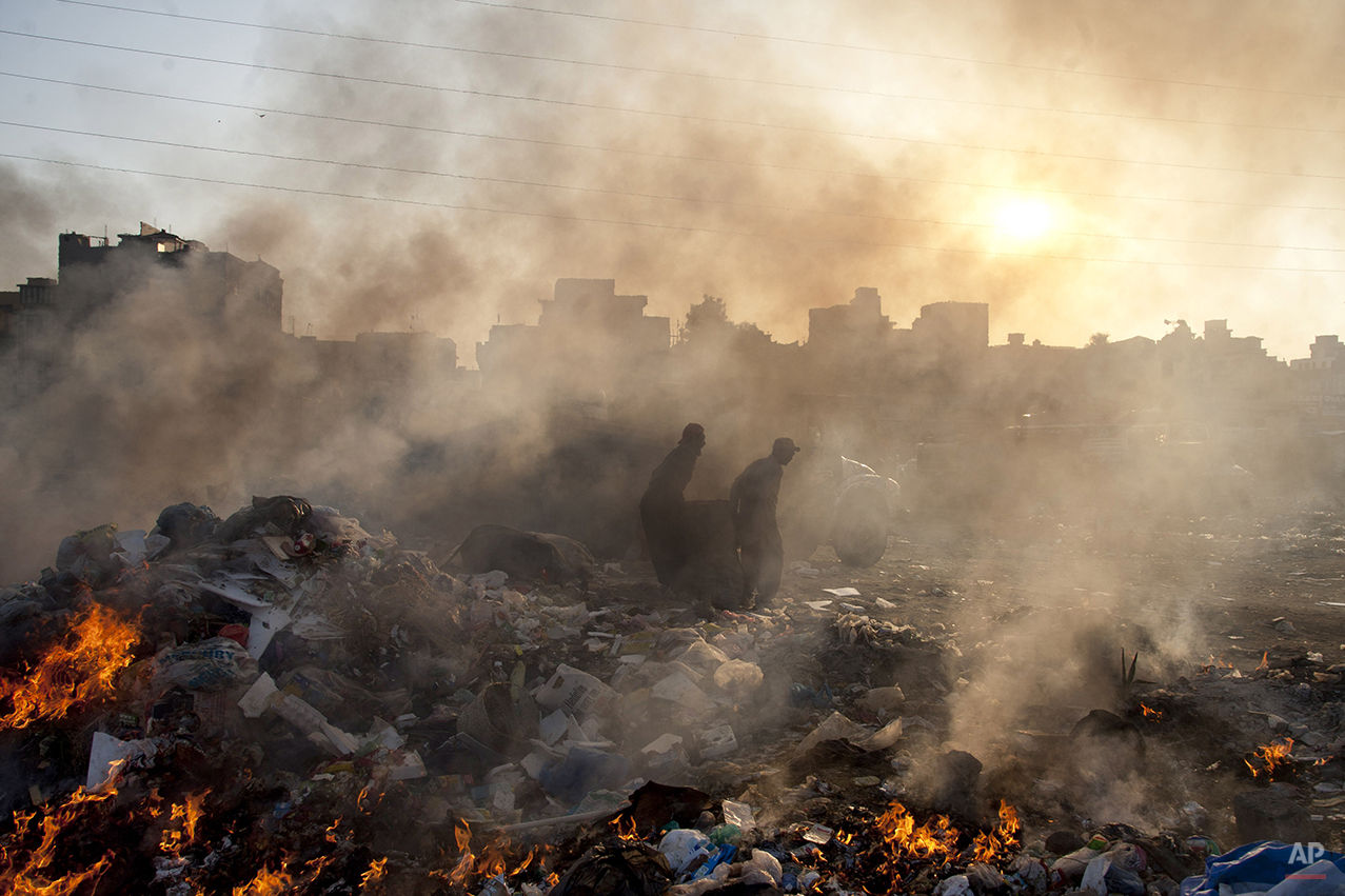  Afghan refugees collect recyclable items from a a heap of garbage to earn their livings, Wednesday, Jan. 28, 2015. (AP Photo/Shakil Adil) 