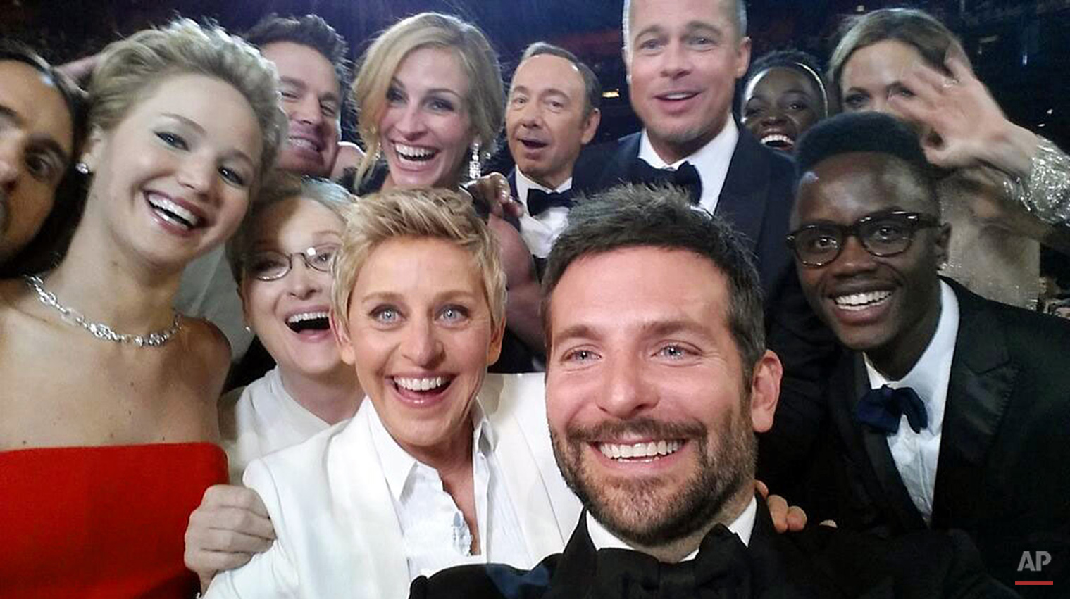  This image released by Ellen DeGeneres shows actors, front row from left, Jared Leto, Jennifer Lawrence, Meryl Streep, Ellen DeGeneres, Bradley Cooper, Peter Nyong’o Jr. and, second row, from left, Channing Tatum, Julia Roberts, Kevin Spacey, Brad P