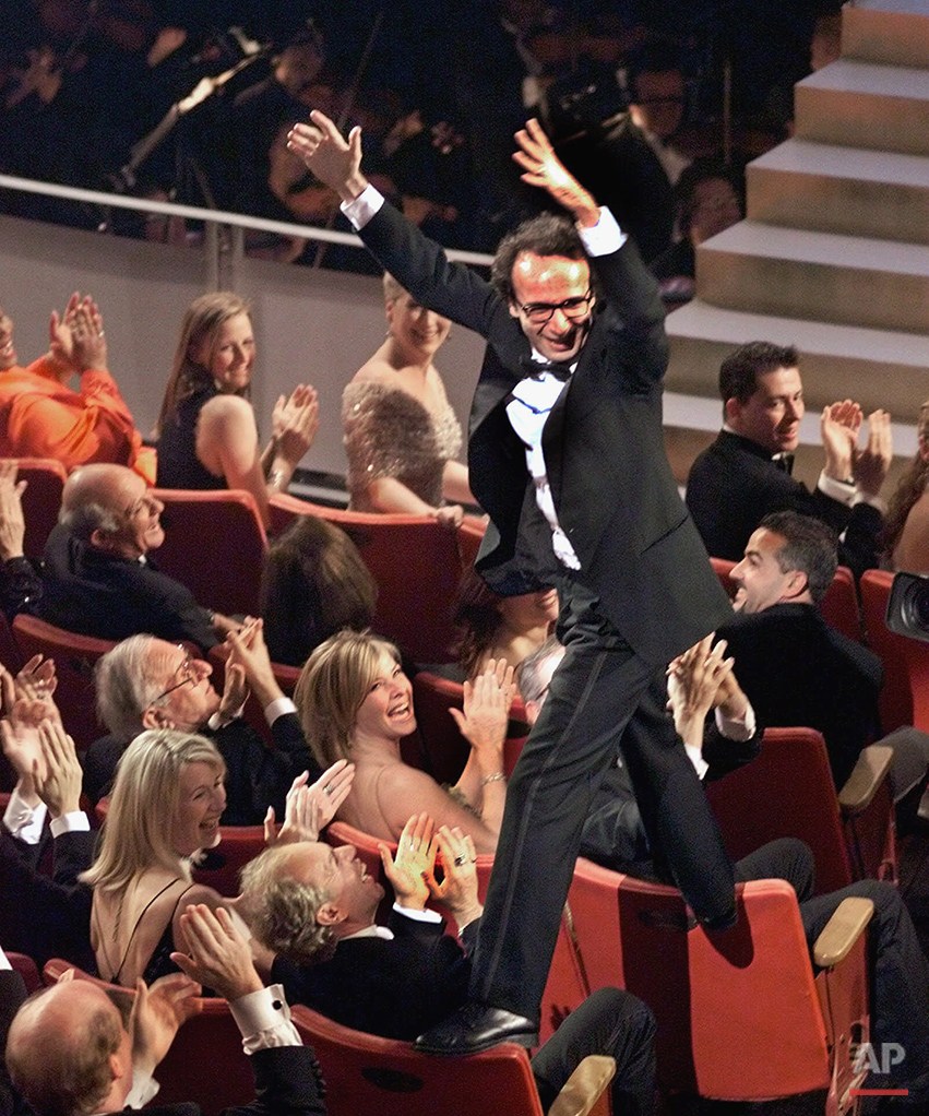  Director and actor Roberto Benigni jumps on the back of some chairs in excitement after winning the Oscar for best foreign language film for "Life is Beautiful," during the 71st Annual Academy Awards at the Dorothy Chandler Pavilion of the Los Angel