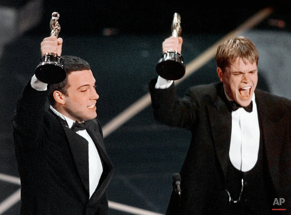 Ben Affleck and Matt Damon, right, react to winning the Oscar for Best Original Screenplay for "Good Will Hunting" at the 70th Academy Awards in Los Angeles Monday, March 23, 1998. (AP Photo/Susan Sterner)