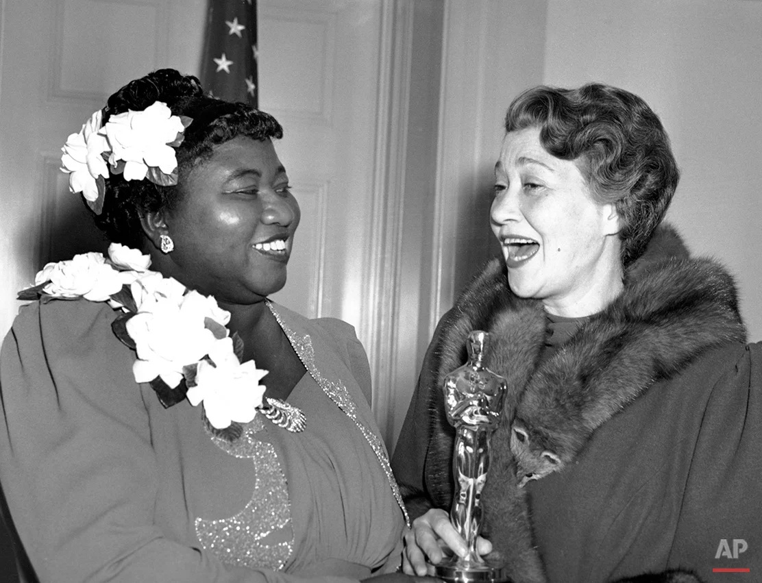 Hattie McDaniel, left, was given the Motion Picture Academy award for the best performance of an actress in a supporting role in 1939 for her work as "Mammy" in the film version of "Gone With the Wind" on Feb. 29, 1940 in Los Angeles, Calif. The presentation of the award was given by actress Fay Bainter, right. (AP Photo)