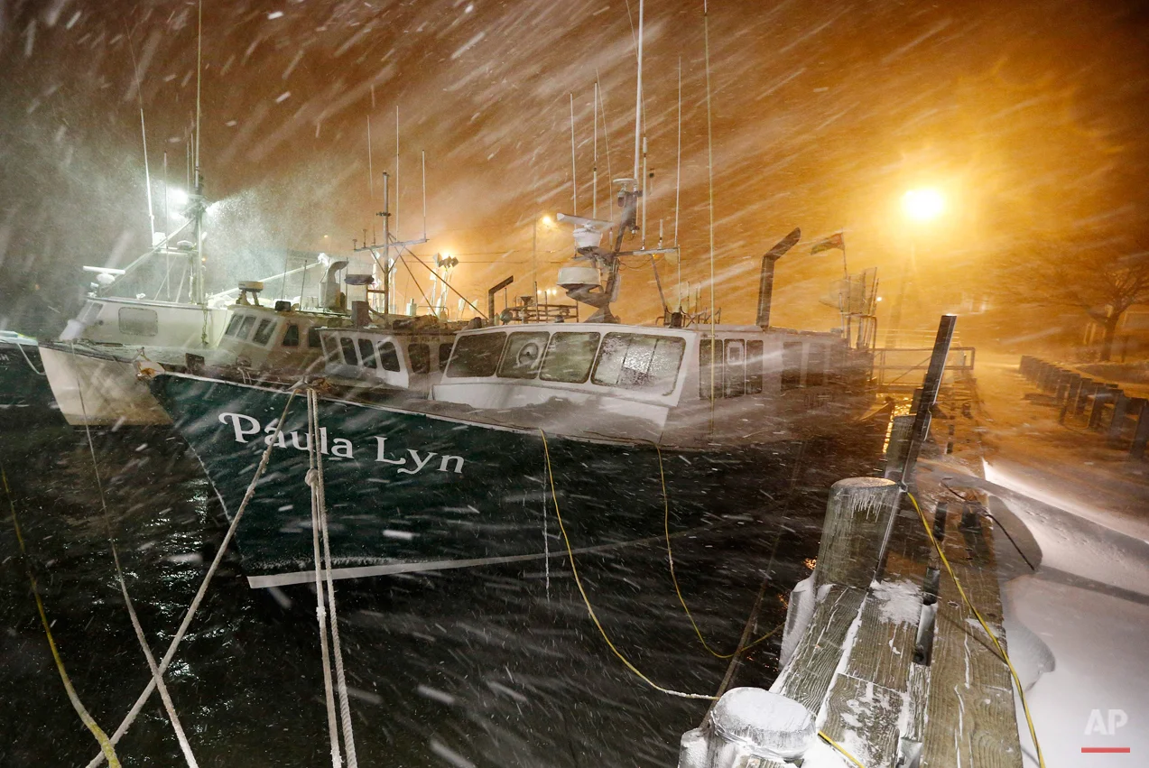 Fishing boats ride out the storm at dock in Scituate, Mass., Tuesday, Jan. 27, 2015. The winter storm packing blizzard conditions spun up the East Coast early Tuesday, pounding parts of coastal New Jersey northward through Maine with high winds and heavy snow. (AP Photo/Michael Dwyer)