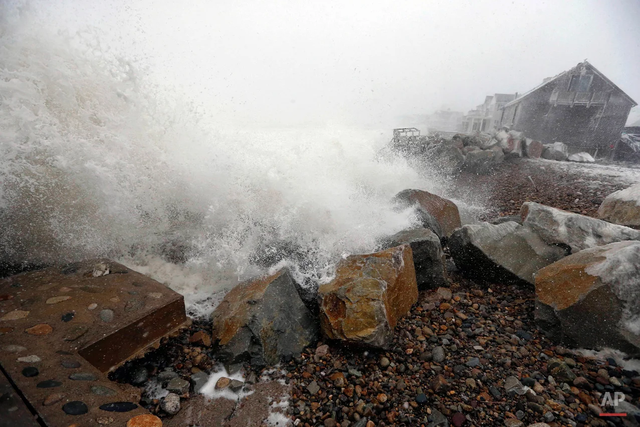 Waves breach a damaged sea wall during a winter storm in Marshfield, Mass., Tuesday, Jan. 27, 2015. A blizzard with 70 mph winds slammed Boston and other parts of New England. (AP Photo/Michael Dwyer)