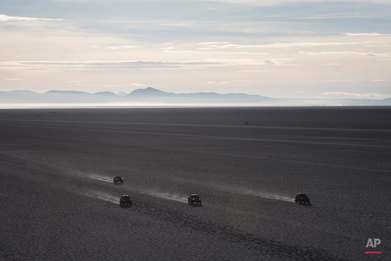 Competitors race across the Uyuni salt flats during the eighth stage of the Dakar Rally 2015 between Uyuni, Bolivia, and Iquique, Chile, Sunday, Jan. 11, 2015. The race will finish on Jan. 17 in Argentina where it started. (AP Photo/Felipe Dana)