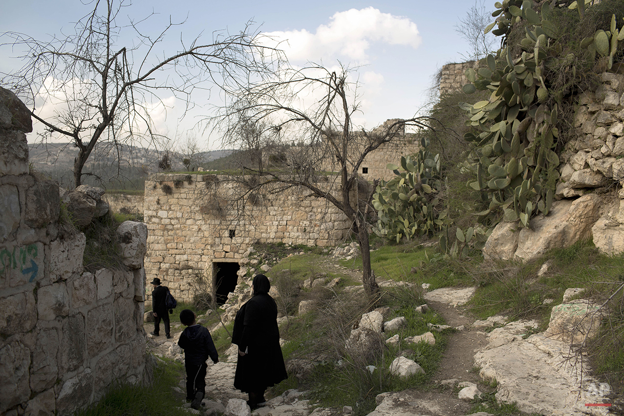  Ultra Orthodox Jewish family members tour in Lifta, located in Jerusalem's mountains, Thursday, Jan. 30, 2014. (AP Photo/Oded Balilty) 