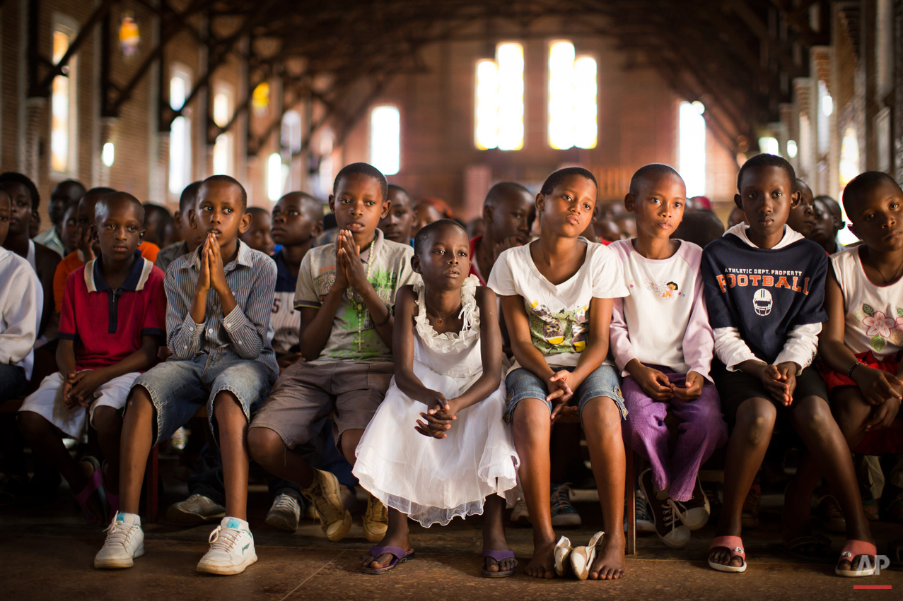 Rwandan children listen and pray during a Sunday morning service at the Saint-Famille Catholic church, the scene of many killings during the 1994 genocide, in the capital Kigali, Rwanda Sunday, April 6, 2014. Rwanda will commemorate on Monday the 20