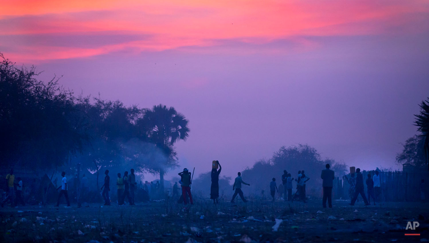  Displaced people who fled the recent fighting between government and rebel forces in Bor by boat across the White Nile, prepare to sleep in the open at night in the town of Awerial, South Sudan Wednesday, Jan. 1, 2014. The international Red Cross sa