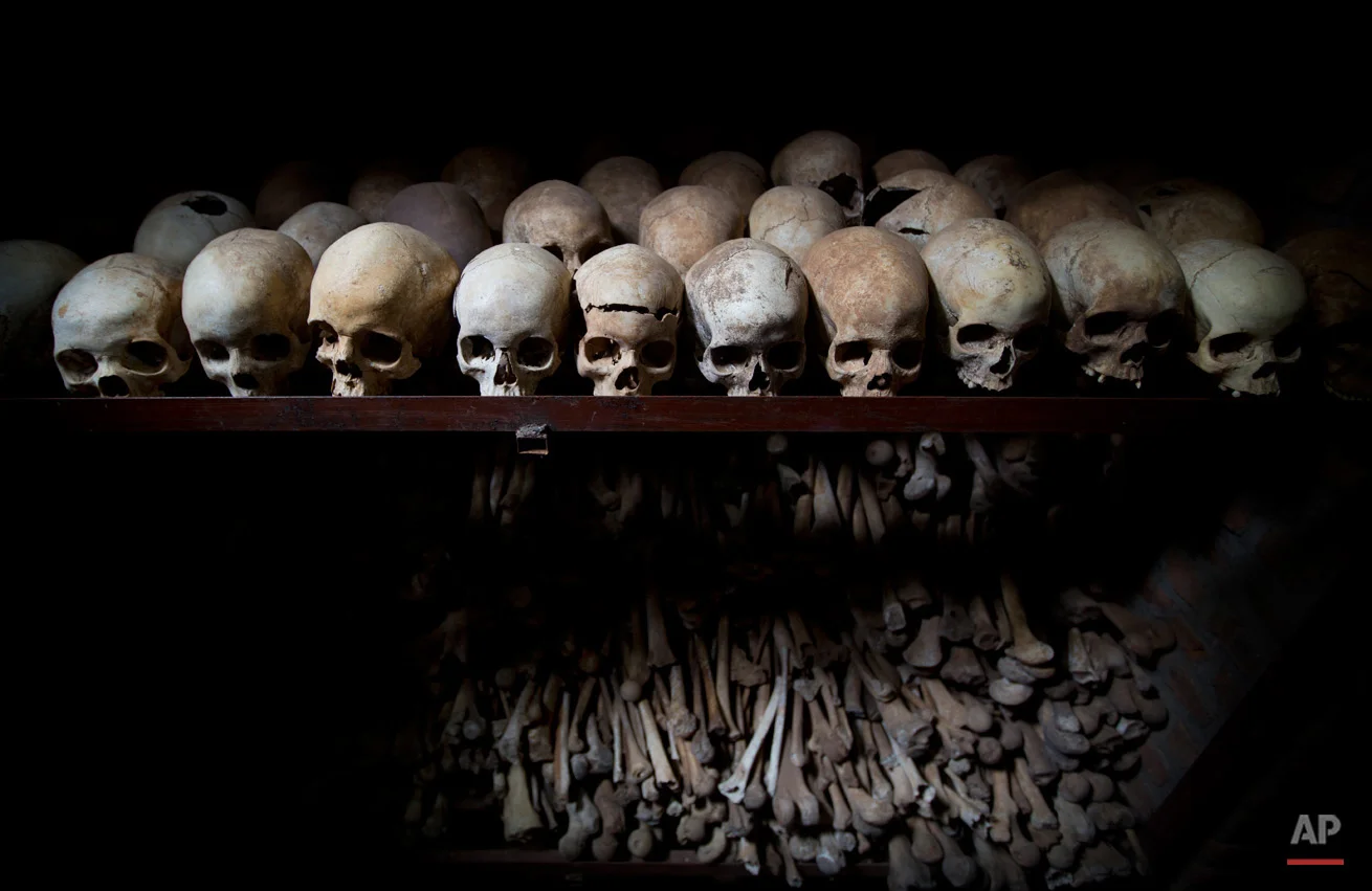 The skulls and bones of some of those who were slaughtered as they sought refuge inside the church, are laid out on shelves in an underground vault as a memorial to the thousands who were killed in and around the Catholic church during the 1994 genocide in Nyamata, Rwanda, Friday, April 4, 2014. The country will commemorate on April 7, 2014 the 20th anniversary of the genocide when ethnic Hutu extremists killed neighbors, friends and family during a three-month rampage of violence aimed at ethnic Tutsis and some moderate Hutus, leaving a death toll that Rwanda puts at 1,000,050. (AP Photo/Ben Curtis)