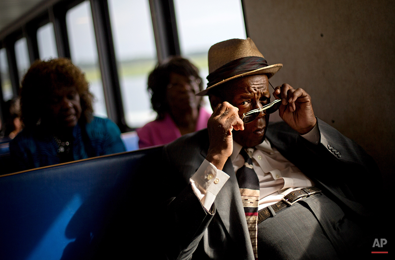  Eddie Wilson, 65, puts on his glasses while riding the ferry from the mainland to attend a church service for the 129th anniversary of St. Luke Baptist Church on Sapelo Island, Ga. on Sunday, June 9, 2013. Isolated over time to the Southeast’s barri
