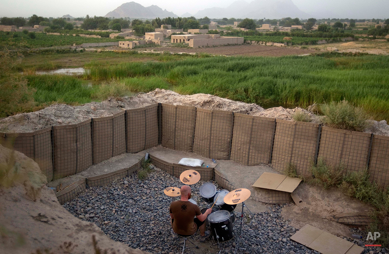  Canadian Forces soldier, Cpl. Ben Vandandaigue, plays on a drum kit, Friday, June 24, 2011, on Forward Operating Base Sperwan Ghar overlooking the Panjwaii district of Kandahar province, Afghanistan. (AP Photo/David Goldman) 