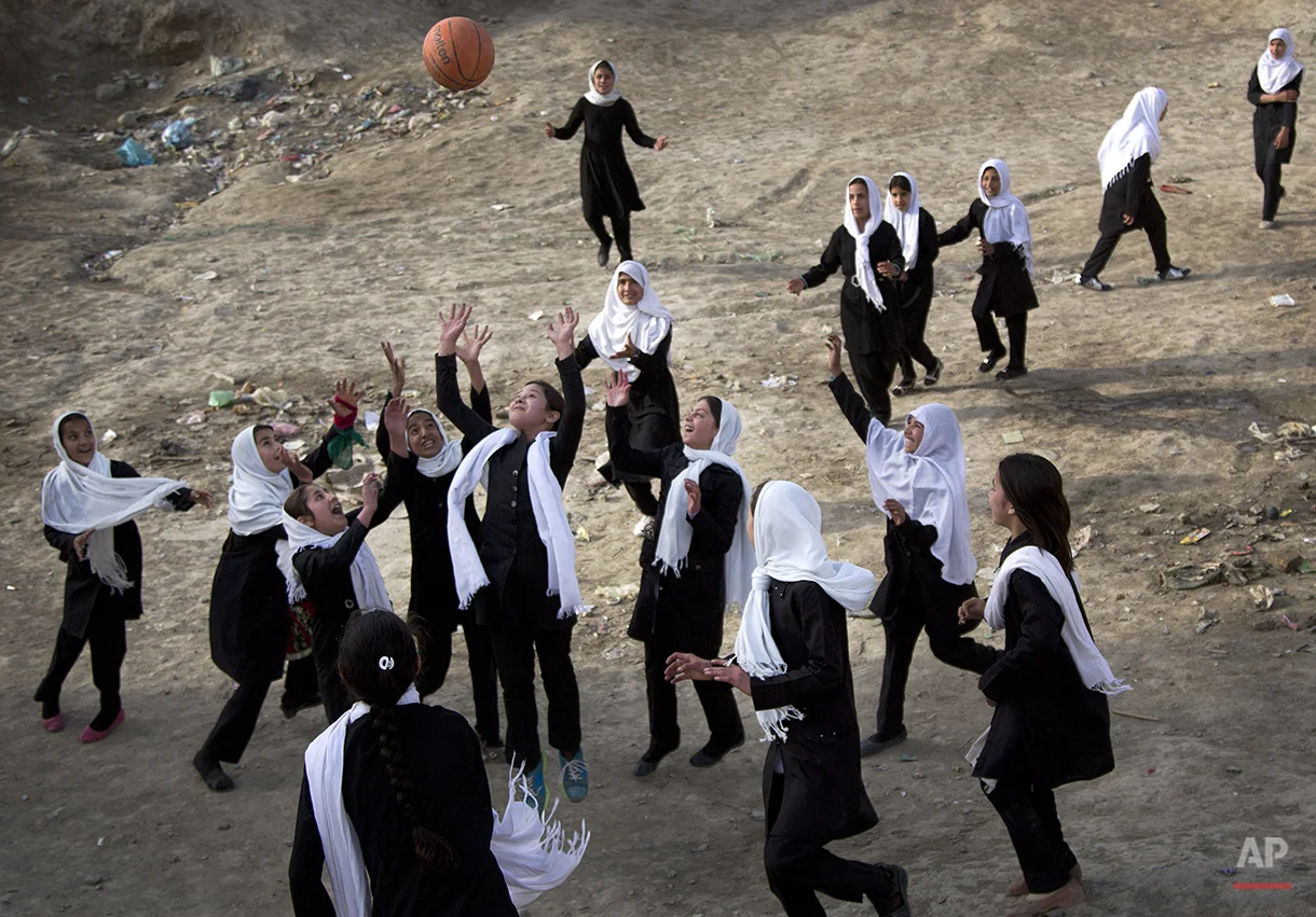 Afghani schoolgirls play volleyball with a basketball during a break at their girls school in the old town of Kabul, Sunday, April 7, 2013. In the past twelve years many girls have returned to school in Afghanistan while under Taliban rule girls where banned from attending school. (AP Photo/Anja Niedringhaus)