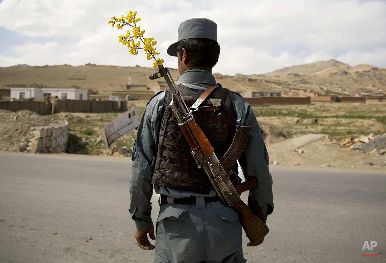 An Afghan National Police officer mans a checkpoint on the outskirts of Maidan Shahr, Wardak province, Wednesday, May 15, 2013. The National Police and Army are providing security unaided by international troops now in most of Afghanistan. (AP Photo/Anja Niedringhaus)