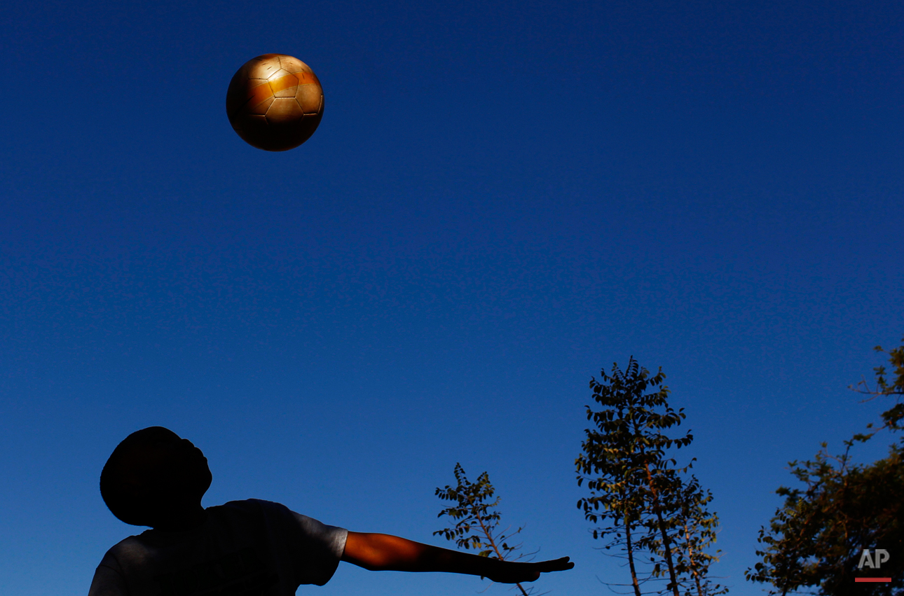  A youth plays with a soccer ball before the World Cup group F soccer match between Italy and New Zealand at Mbombela Stadium in Nelspruit, South Africa, Sunday, June 20, 2010.  (AP Photo/Bernat Armangue) 