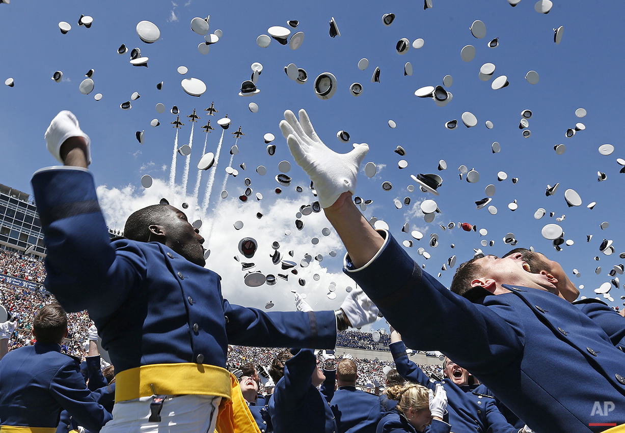  Air Force Academy graduates throw their caps into the air as F-16 jets from the Thunderbirds make a flyover, at the completion of the graduation ceremony for the class of 2014, at the U.S. Air Force Academy, in Colorado, Wednesday, May 28, 2014.  (A