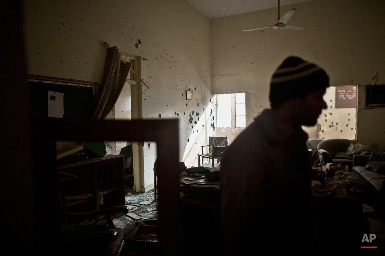 A Pakistani man checks the damage inside the room of headmaster Tahira Kazi, 58, who was killed in Tuesday's Taliban attack on a military-run school in Peshawar, Pakistan, Thursday, Dec. 18, 2014. The Taliban massacre that killed more than 140 people, mostly children, at the military-run school in northwestern Pakistan left a scene of heart-wrenching devastation, pools of blood and young lives snuffed out as the nation mourned and mass funerals for the victims got underway. (AP Photo/Muhammed Muheisen)