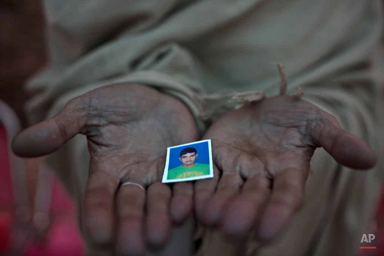 Pakistani Sayed Shah, shows a picture of his son Zulqarnain, 17, a student who was killed in last Tuesday's Taliban attack on a military-run school, in Peshawar, Pakistan, Thursday, Dec. 18, 2014. The Taliban massacre that killed more than 140 people, mostly children, at a military-run school in northwestern Pakistan left a scene of heart-wrenching devastation, pools of blood and young lives snuffed out as the nation mourned and mass funerals for the victims got underway. (AP Photo/Muhammed Muheisen)