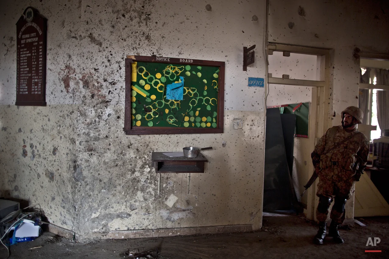 A wall riddled with bullet marks, inside the Army Public School attacked last Tuesday by Taliban gunmen, in Peshawar, Pakistan, Thursday, Dec. 18, 2014. The Taliban massacre that killed more than 140 people, mostly children, at a military-run school in northwestern Pakistan left a scene of heart-wrenching devastation, pools of blood and young lives snuffed out as the nation mourned and mass funerals for the victims got underway. (AP Photo/Muhammed Muheisen)