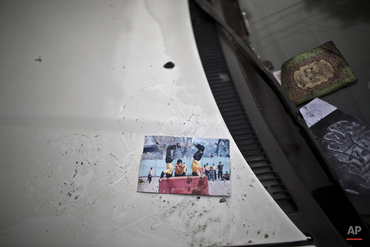  A picture showing schoolchildren playing is left on a car, inside the Army Public School attacked last Tuesday by Taliban gunmen, in Peshawar, Pakistan, Thursday, Dec. 18, 2014. The Taliban massacre that killed more than 140 people, mostly children,