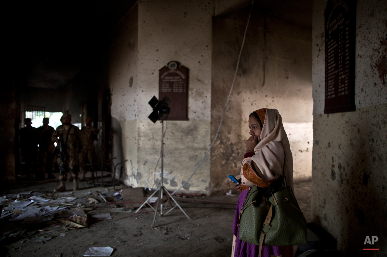  A Pakistani woman looks at the damage inside the Army Public School, attacked Tuesday by Taliban gunmen in Peshawar, Pakistan, Thursday, Dec. 18, 2014. The Taliban massacre that killed more than 140 people, mostly children, at the military-run schoo