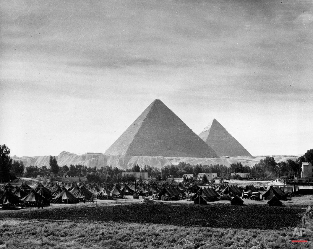  The pyramids of Egypt are contrasted against the pyramidal tents of an army camp set up near Mena House to provide quarters for military police and other military personnel necessary at the Cairo Conference in Nov. 1943.  The World War II meeting be