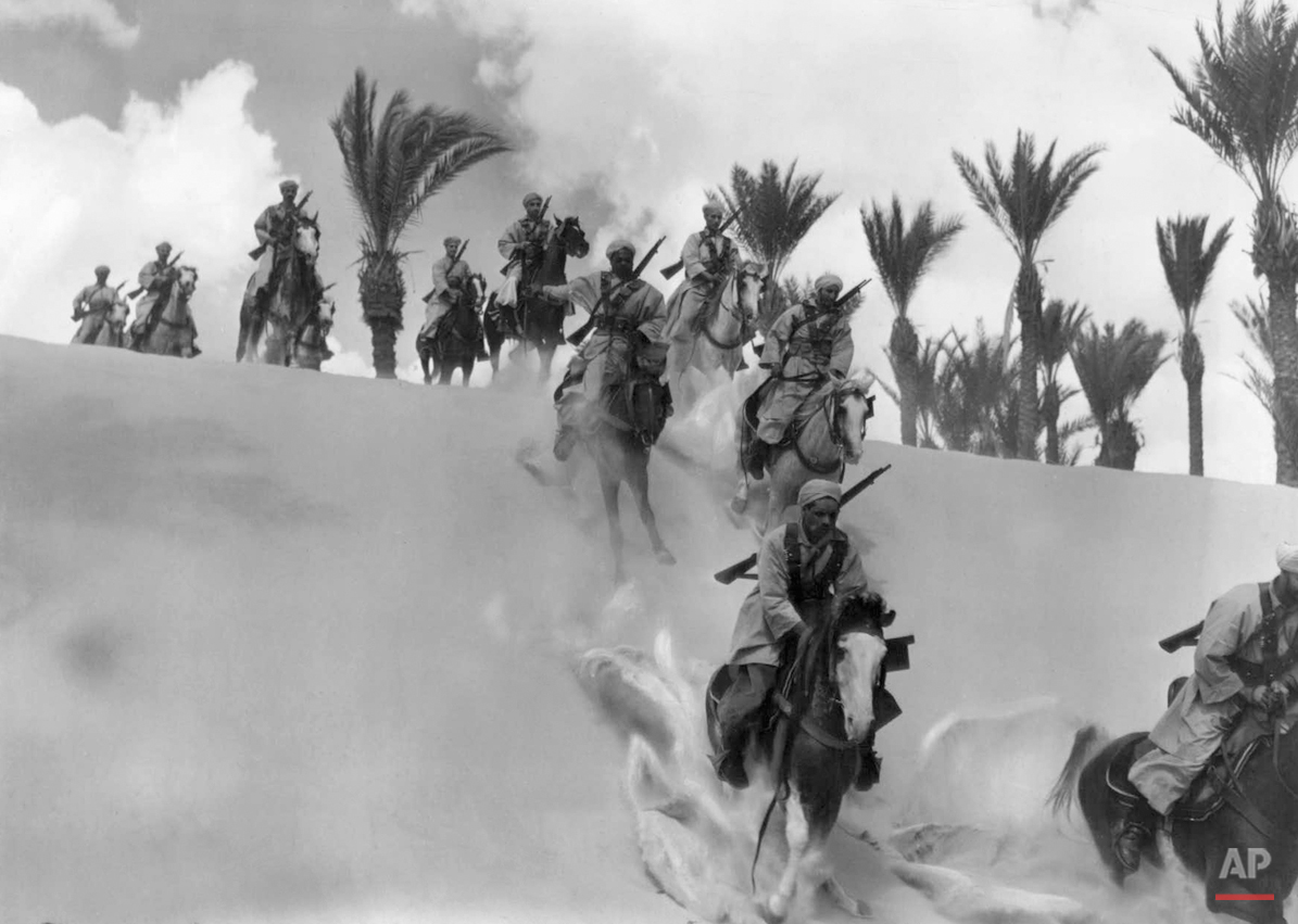  A patrol of Spahis, famous French Colonial cavalrymen, gallop their mounts down the side of a dune in the Egyptian desert, Jan. 3, 1941. These troops are reported to be among the French forces which remained allies to Great Britain after the armisti