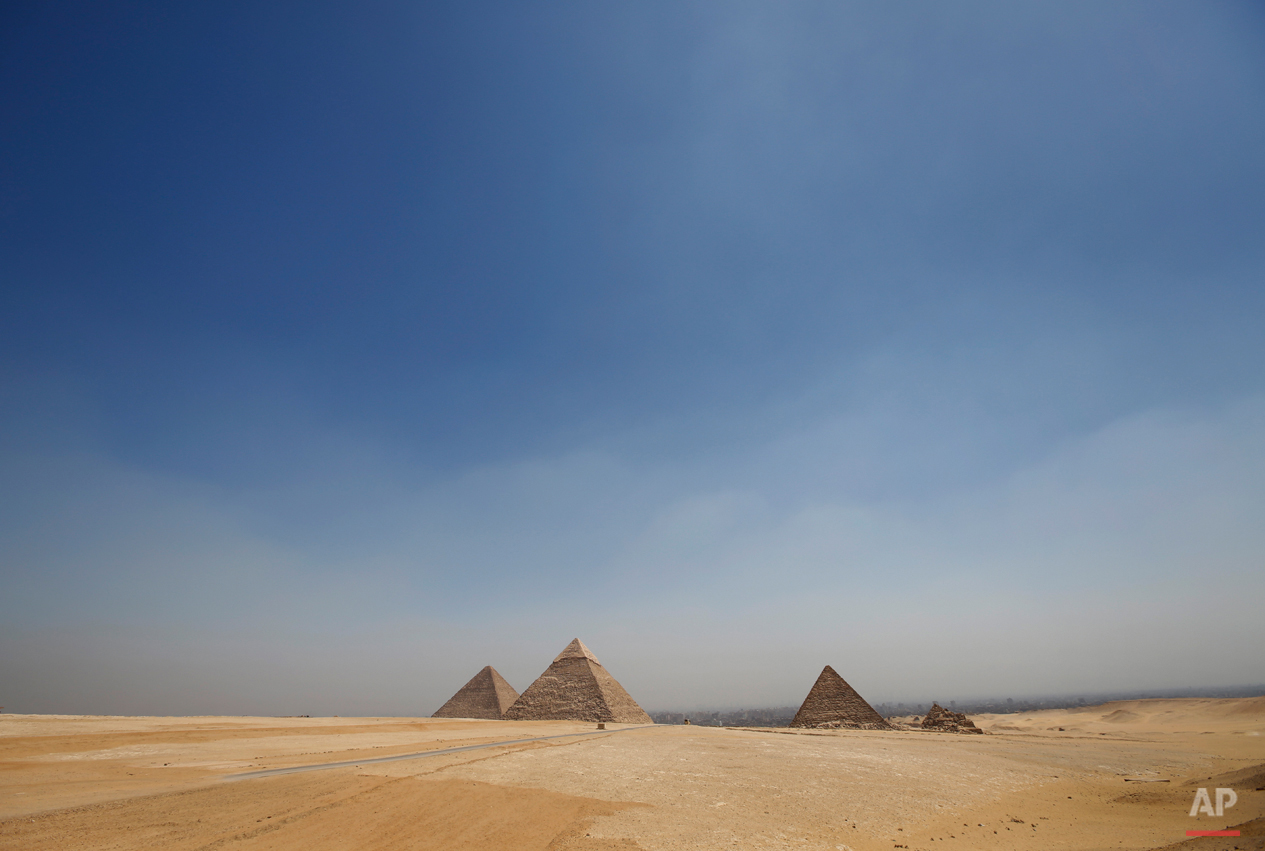  In this Saturday, Sept. 7, 2013 photo, the Giza Pyramids stand out from the desert on the horizon, near Cairo, Egypt. Before the 2011 revolution that started Egypt's political roller coaster, sites like the pyramids were often overcrowded with visit