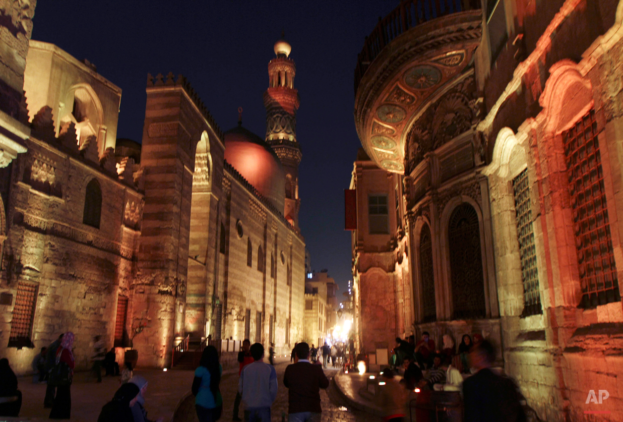  Egyptians walk in Al Muezz street in Al Azhar mosque area, in Cairo, Egypt, Tuesday, Dec. 7, 2010.  (AP Photo/ Khalil Hamra) 