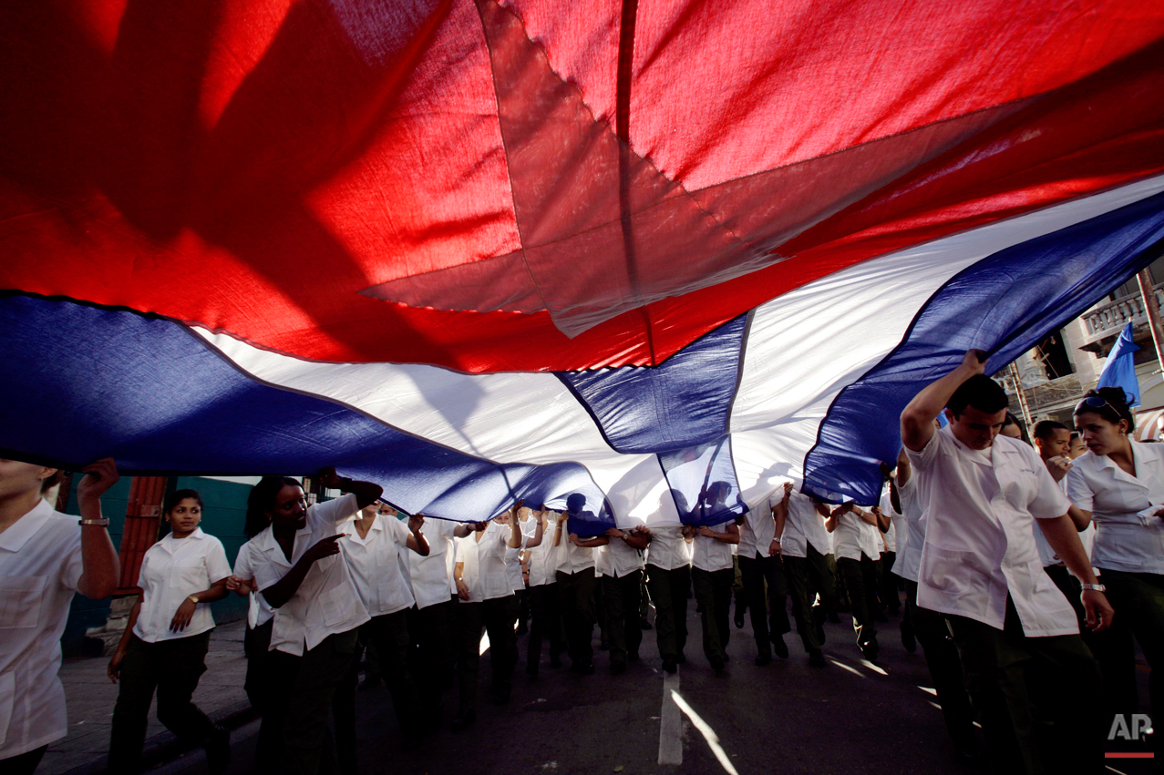  Medical science students hold up a Cuban flag during a march to commemorate the 138th anniversary of the execution of eight medicine students by the Spanish colonial government in Havana, Friday, Nov.27, 2009. Thousands  marched to commemorate the e