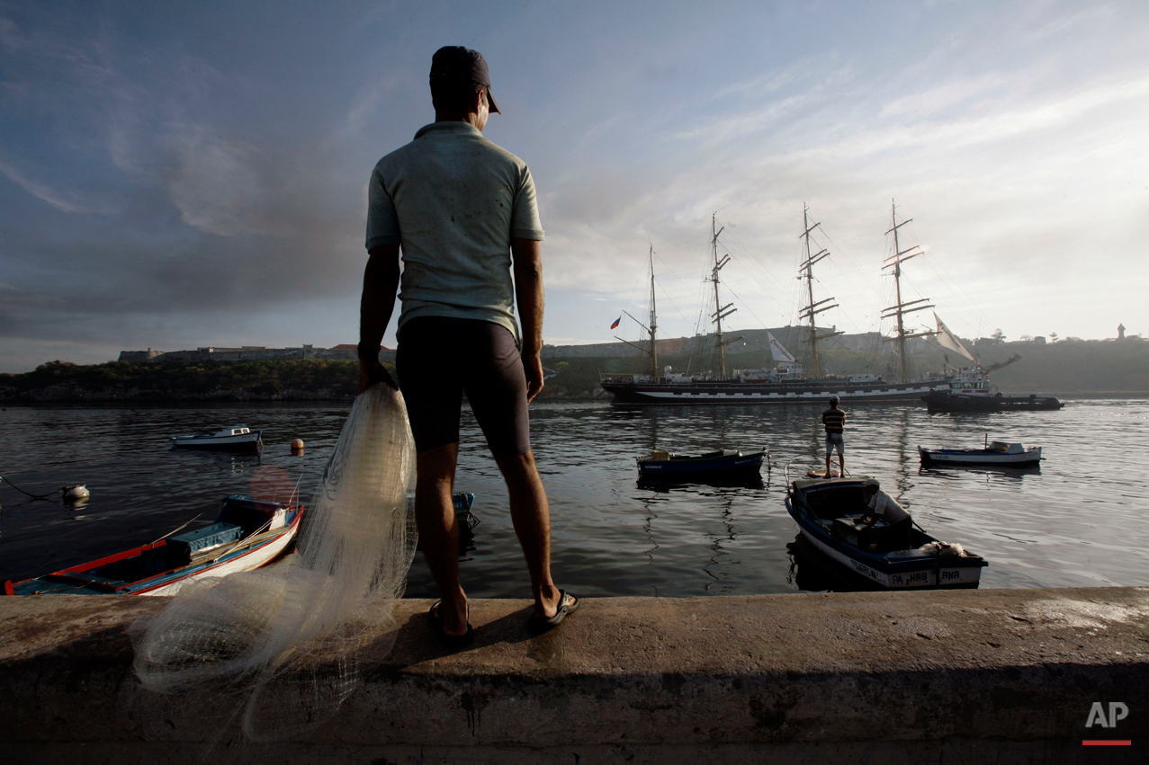 Fishermen watch as Russia's vessel Kruzenshtern, carrying a photo exhibition, arrives to the port of Havana, Friday, April 9, 2010. The Kruzenshtern was built in 1926 and in spite of its age, is one of the jewels of the Russian sailing fleet. (AP Ph