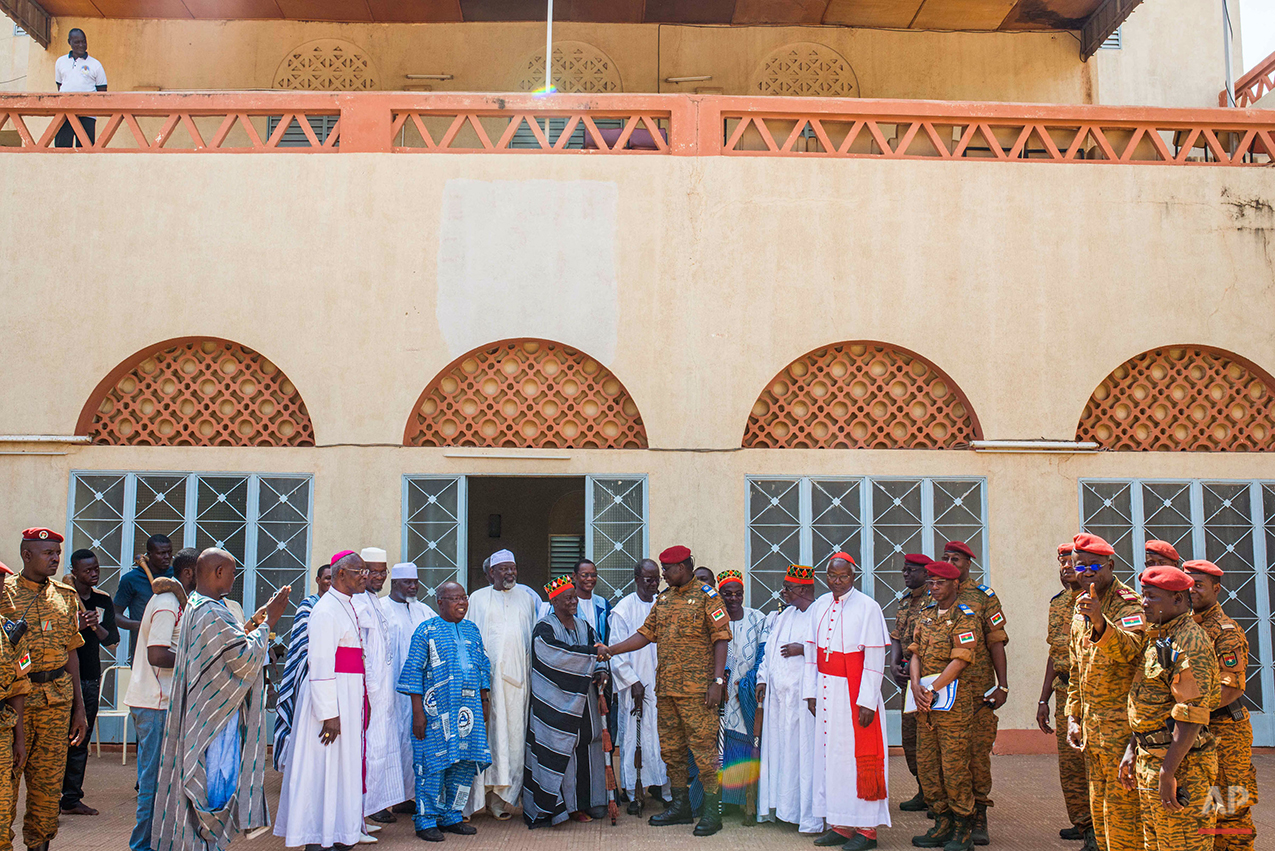  Burkina Faso Lt. Col. Issac Yacouba Zida, center, shakes the hand of  Mossi emperor Mogho Naaba, leader of the Mossi tribe  and the largest ethnicity in the country, in the city of Ouagadougou, Burkina Faso, Tuesday, Nov. 4, 2014.  International env