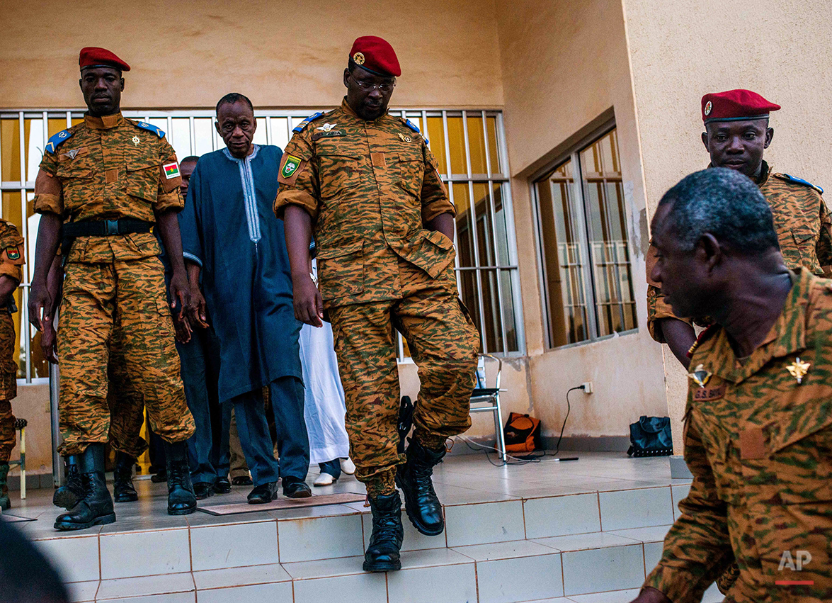  Burkina Faso Lt. Col. Issac Yacouba Zida, center, leaves a government building after meeting with political leaders in Ouagadougou, Burkina Faso, Tuesday, Nov. 4, 2014. International envoys tried Tuesday to resolve Burkina Faso's political crisis, w