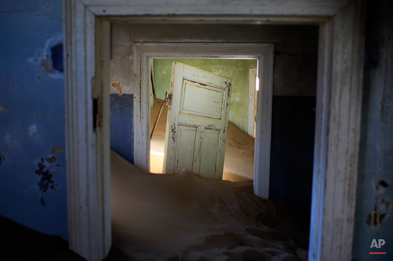  In this July 23, 2013 photo, sand fills an abandoned house in Kolmanskop, Namibia. Kolmanskop, was a diamond mining town south of Namibia, build in 1908 and deserted in 1956. SInce then, the desert slowly reclaims its territory, with sand invading t
