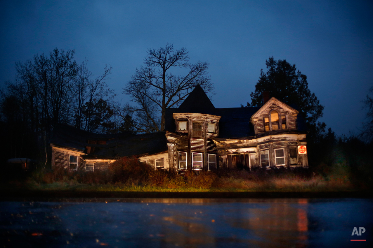  In this Oct. 24, 2014 photo, an uninhabited old farmhouse sags in disrepair during a nor'easter rainstorm in Searsport, Maine. (AP Photo/Robert F. Bukaty) 